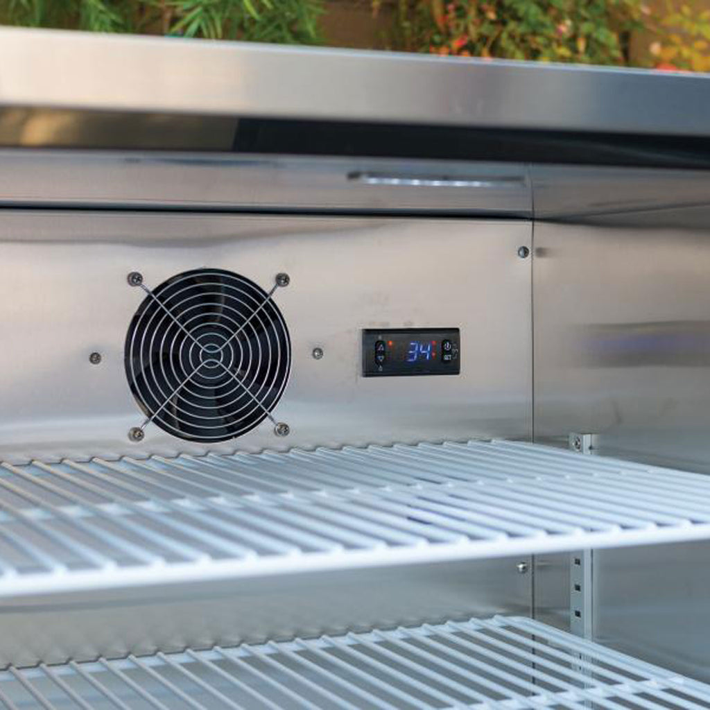 Outdoor refrigerator interior with cooling fan, vented panel, and digital display