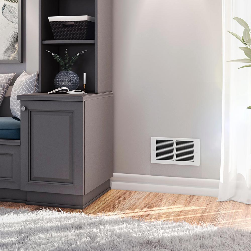 Wall-mounted white air intake grille near baseboard with two black louvered vents