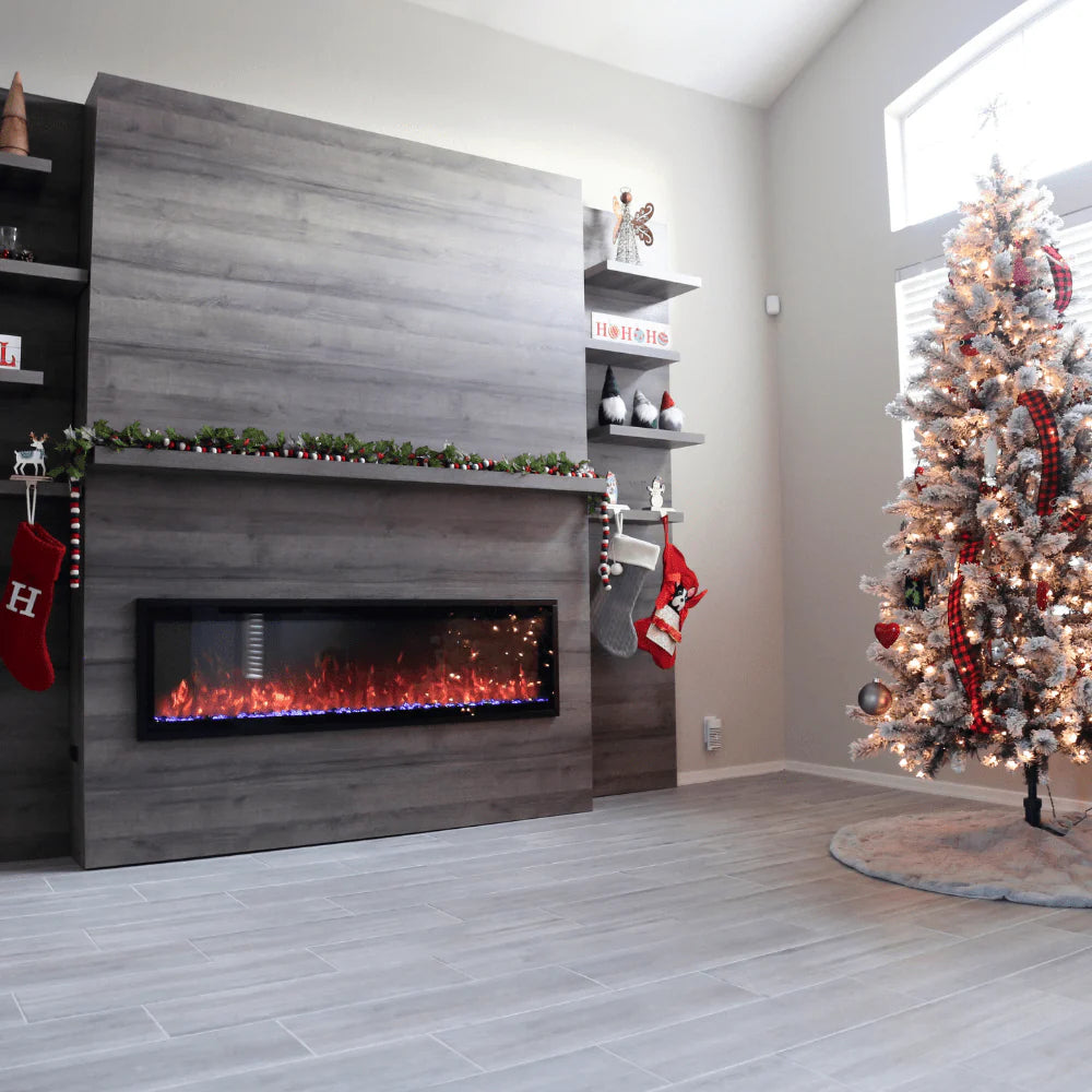 Linear electric fireplace with gray wood media wall, black glass firebox, burning flames