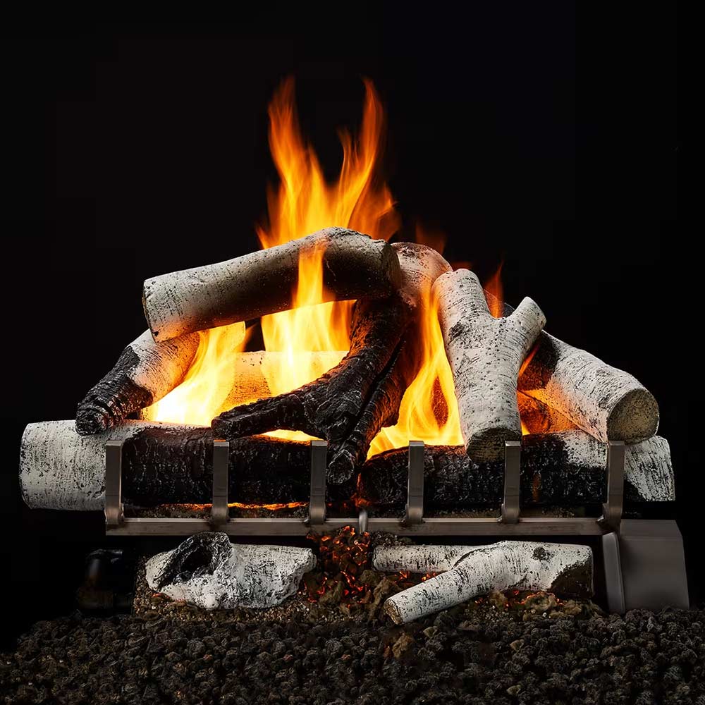 Vented gas log set with gray birch logs on metal grate, tall flames burning