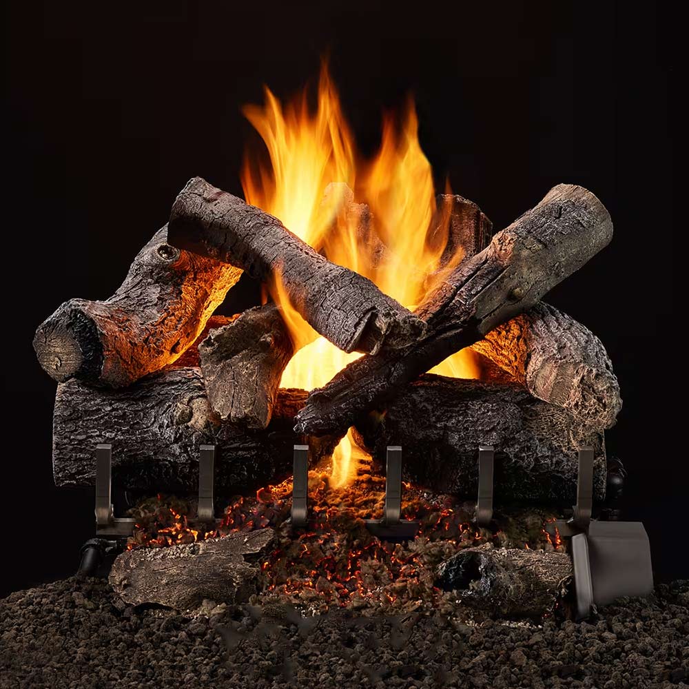 Outdoor vented gas log set with crossed charred logs and tall flames on black burner