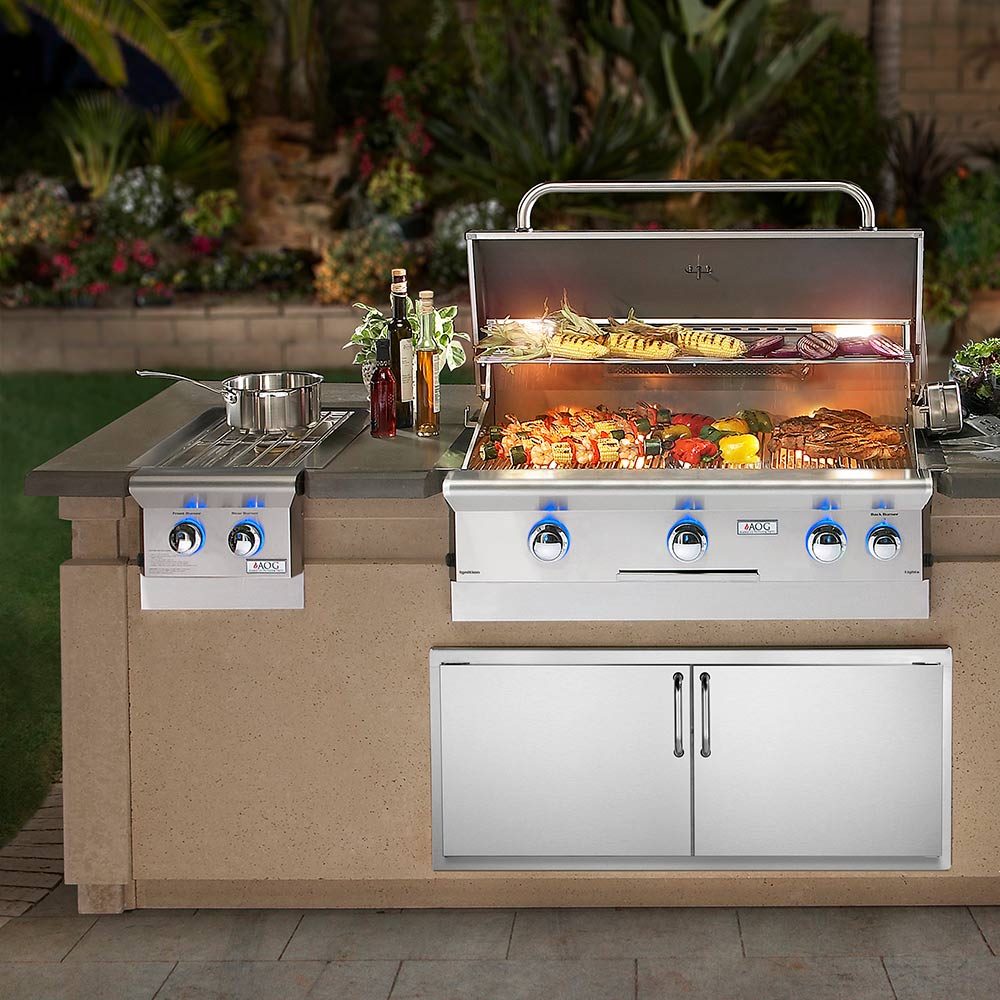 Built-in double side burner grill with lit main burners and open hood