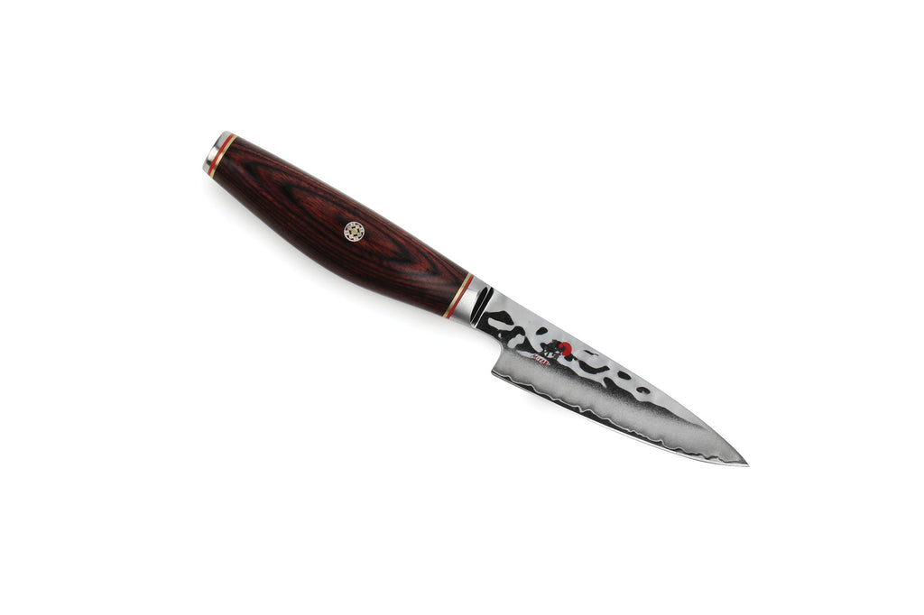 Paring knife with dark wood handle and patterned stainless blade
