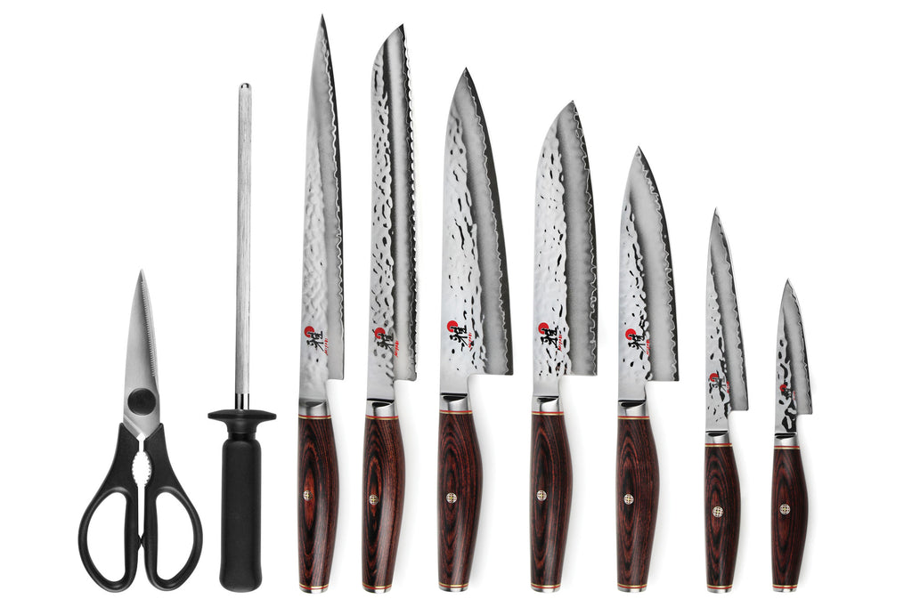 Knife set with multiple stainless blades and dark handle kitchen shears, plus honing rod