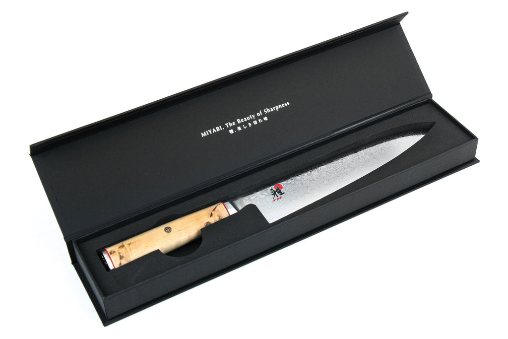 Chef's knife in black gift box with wooden handle and patterned blade