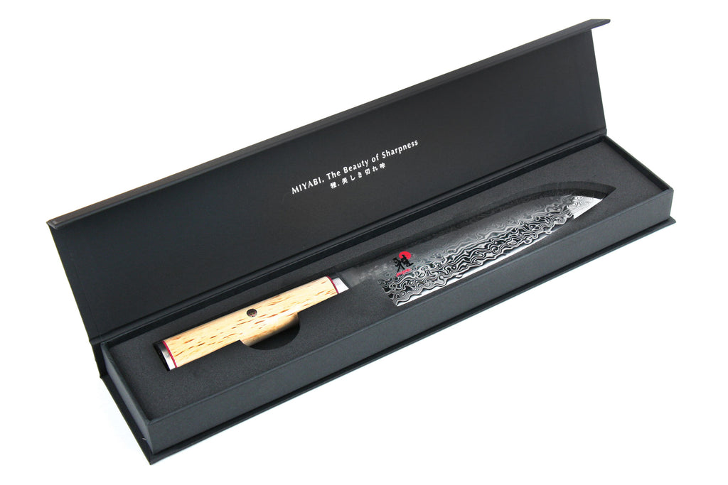 7-inch santoku knife in open box, birchwood handle and patterned steel blade