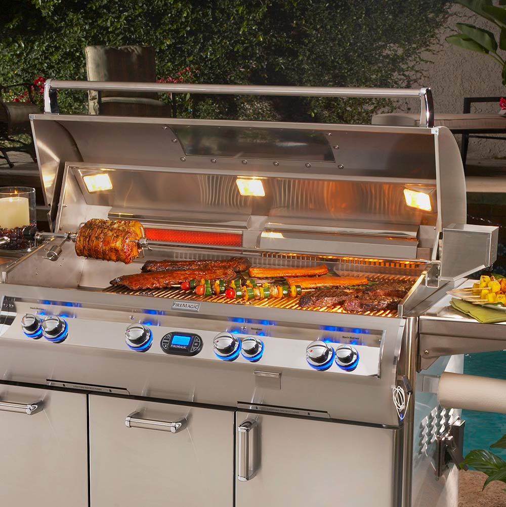 Rotisserie kit on grill: stainless hood, spit with food, control panel