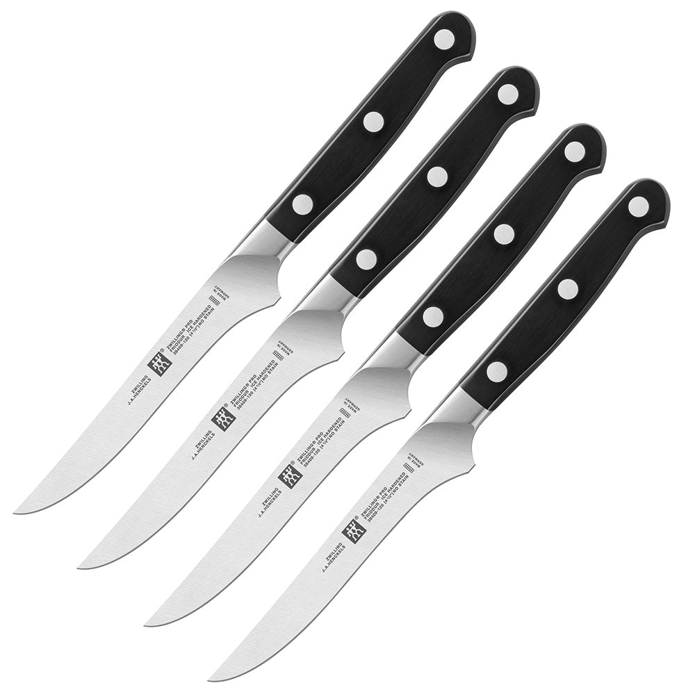 Steak knife set with four black handles and stainless-steel blades