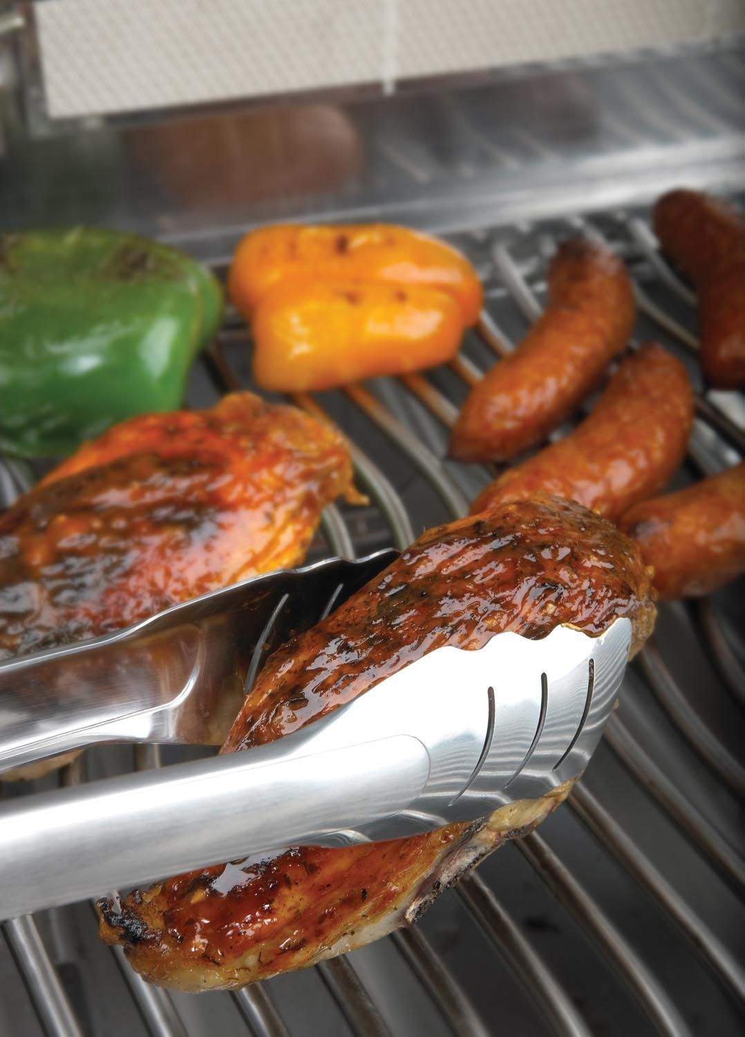Stainless steel locking tongs holding grilled sausages on a barbecue
