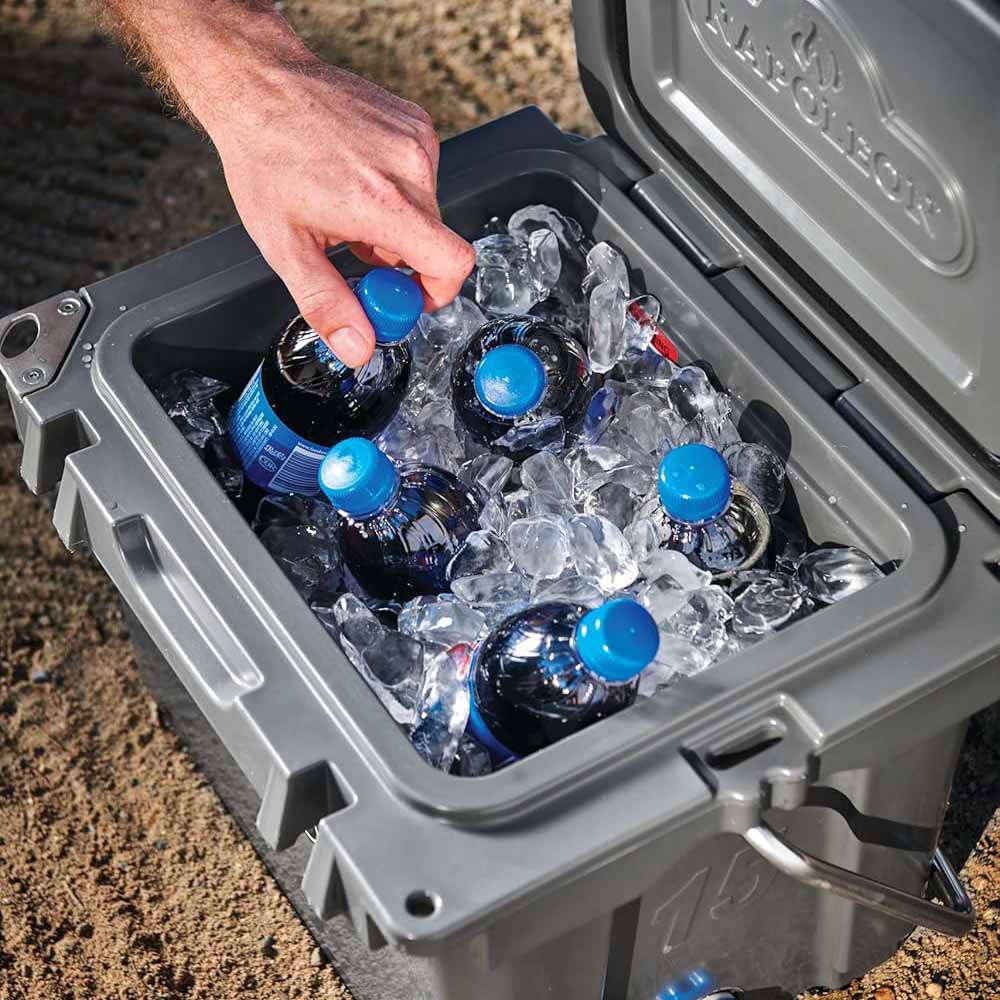 Gray cooler chest filled with ice and blue-capped bottles in open bin