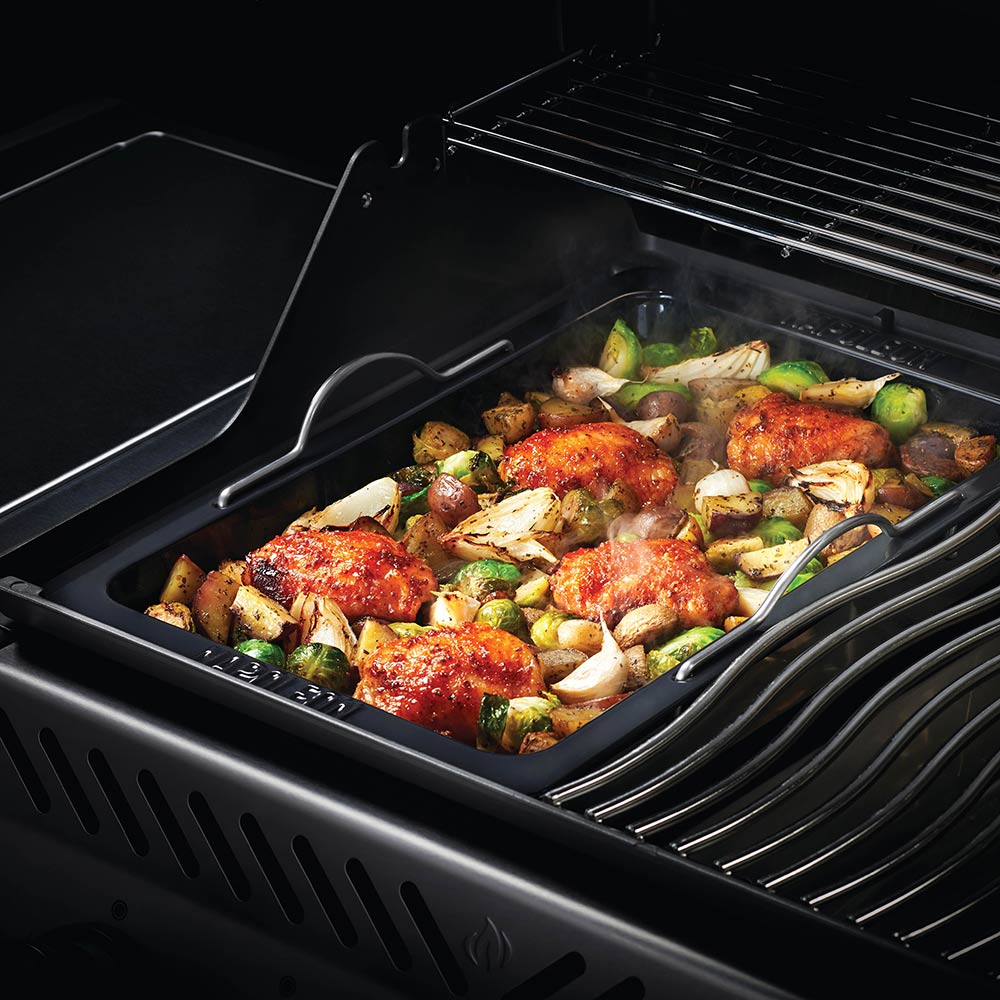 Napoleon Grill roasting pan holding roasted chicken and vegetables inside grill