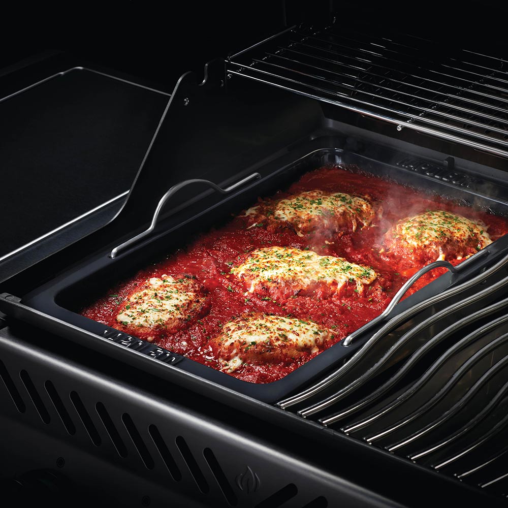 Napoleon Grill roasting pan with seasoned meat and sauce inside grill