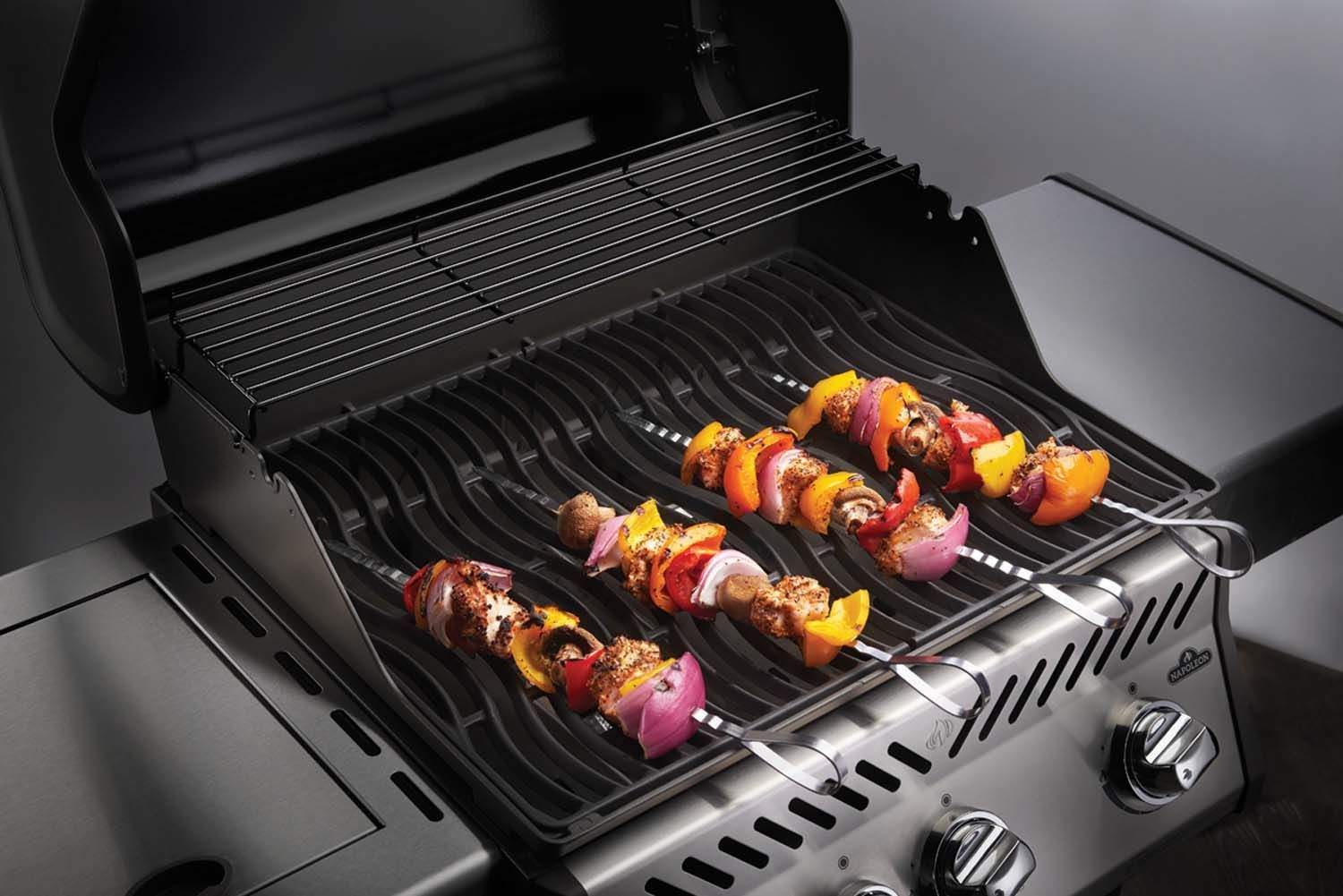 Stainless steel skewers on grill grate with kebabs, looped handles