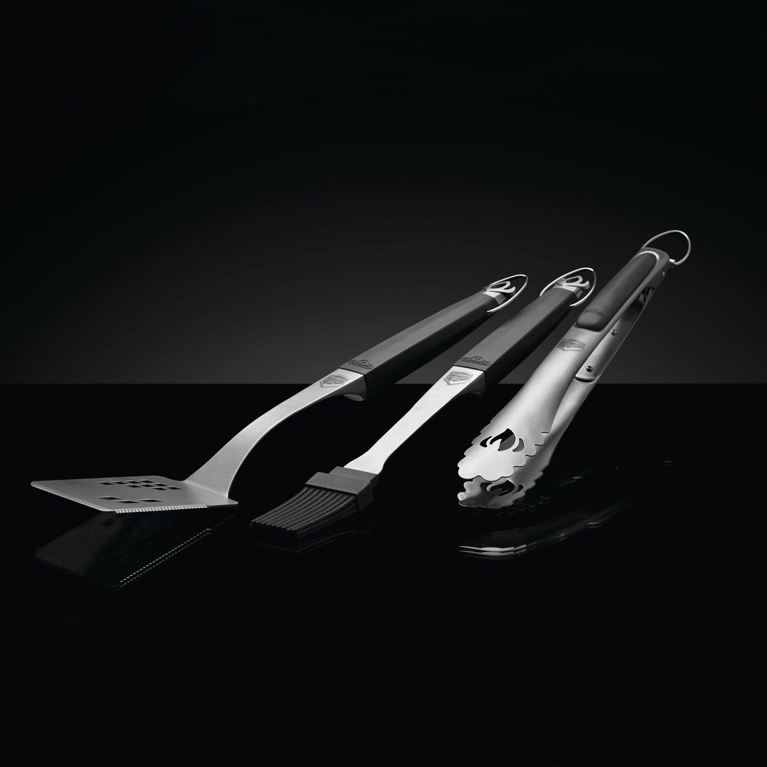 Napoleon 3-piece grill tool set with spatula, fork, and brush, angled