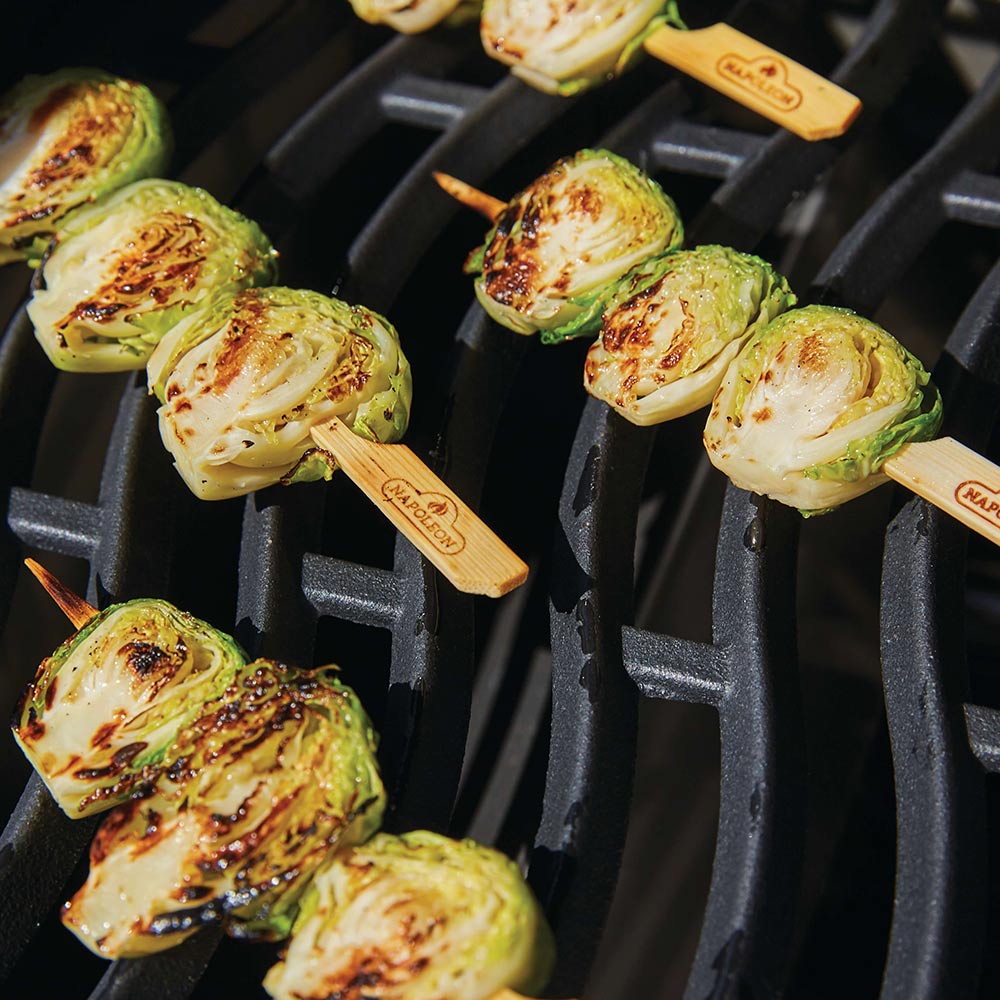 Bamboo skewers with grilled green and white vegetable slices
