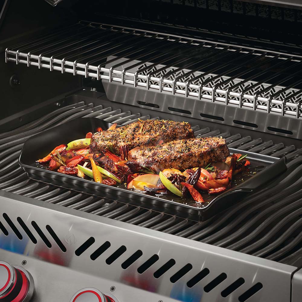 Ridged roasting tray with beer-can holder and roasted chicken on grill rack