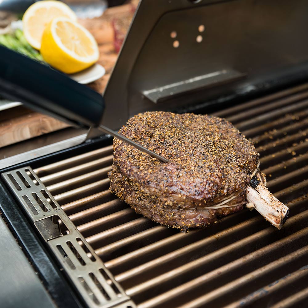 Saber EZ Temp digital thermometer probe on grill steak with thermometer display