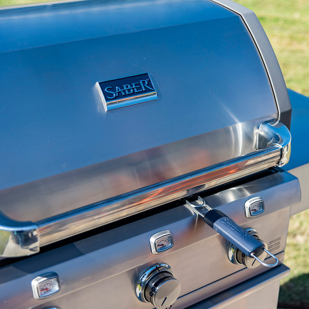 Gas grill lid and control panel with Saber branding