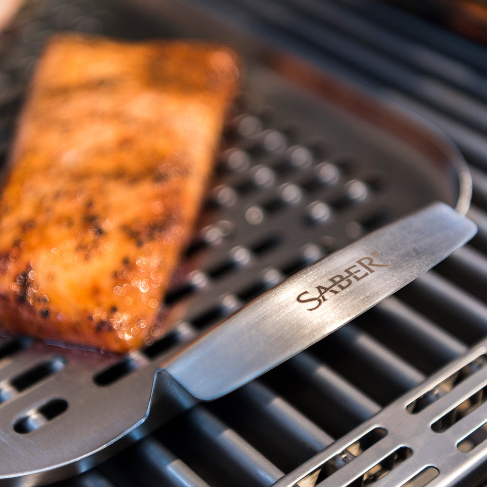 SABER stainless steel tray with cooked salmon on slotted grill surface