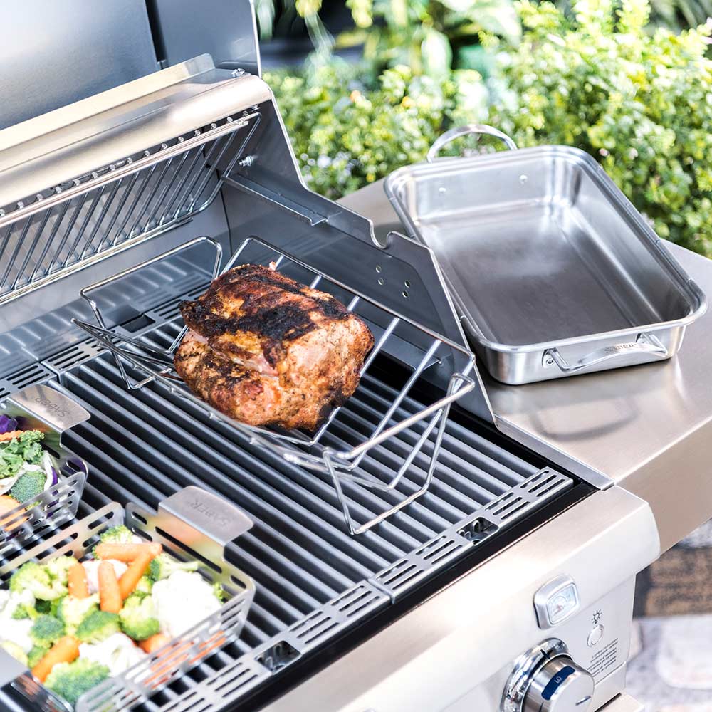 Stainless steel roast rack holding grilled meat on wire grid above grill grates