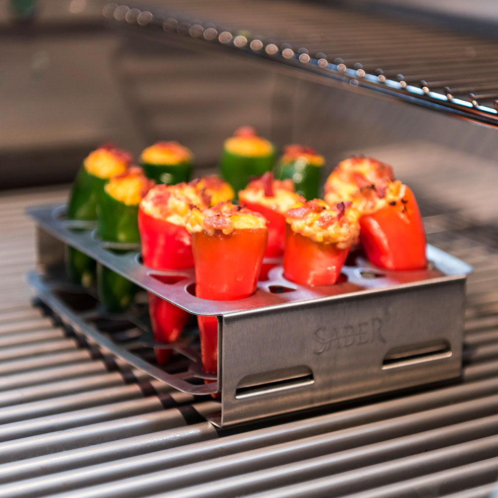 Stainless steel double pepper roaster tray holding stuffed peppers on grill grates