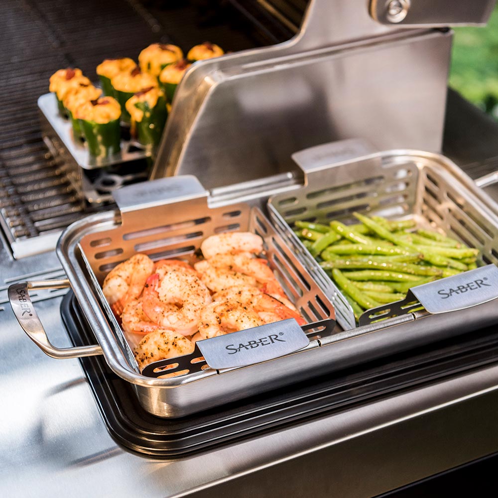 Saber grilling insert trays with shrimp and asparagus in metal basket racks