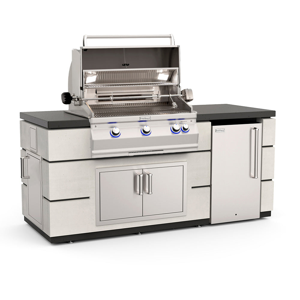 Fire Magic outdoor kitchen island with open gas grill, double cabinet doors, refrigerator