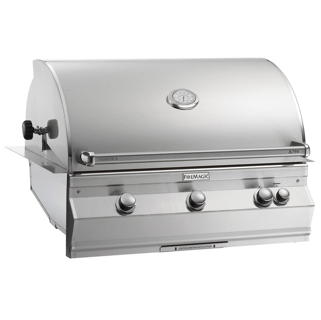 Fire Magic built-in grill with stainless steel hood, control knobs, and side handle