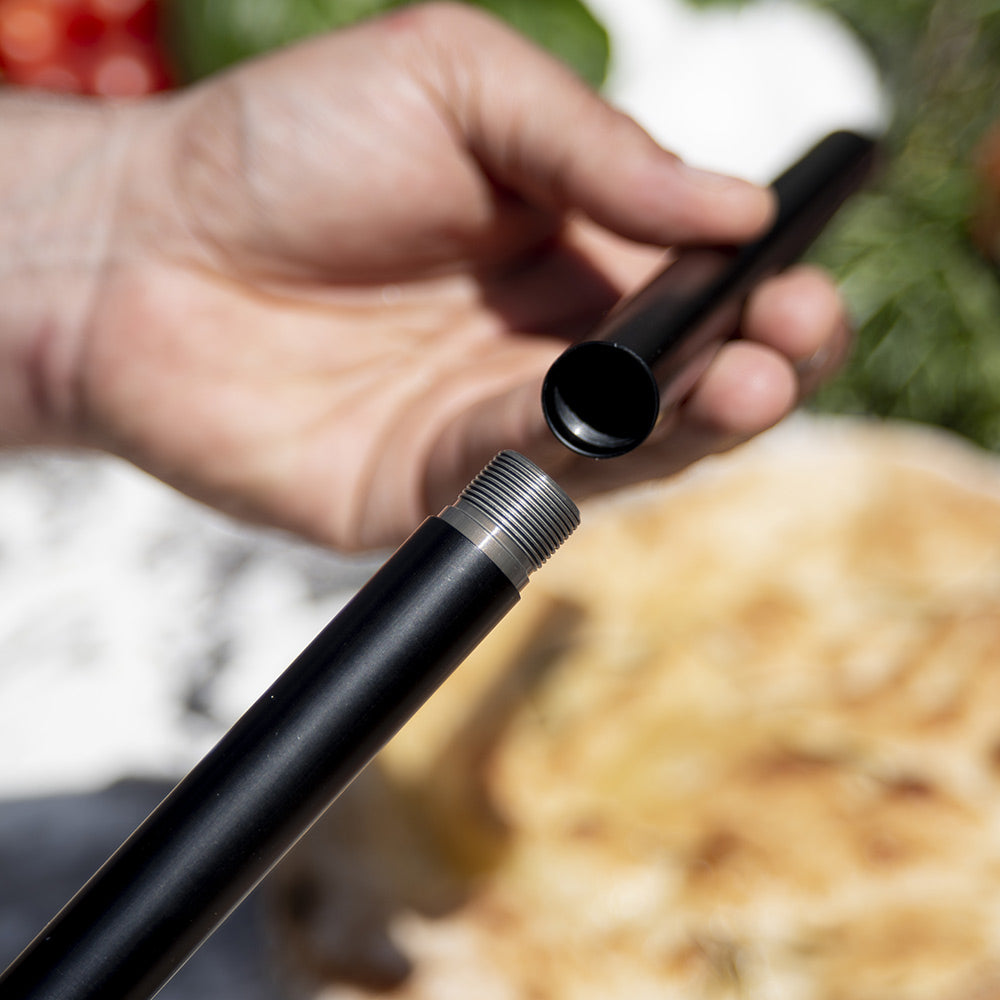Black pizza peel handle close-up with threaded end for lifting and turning pizzas
