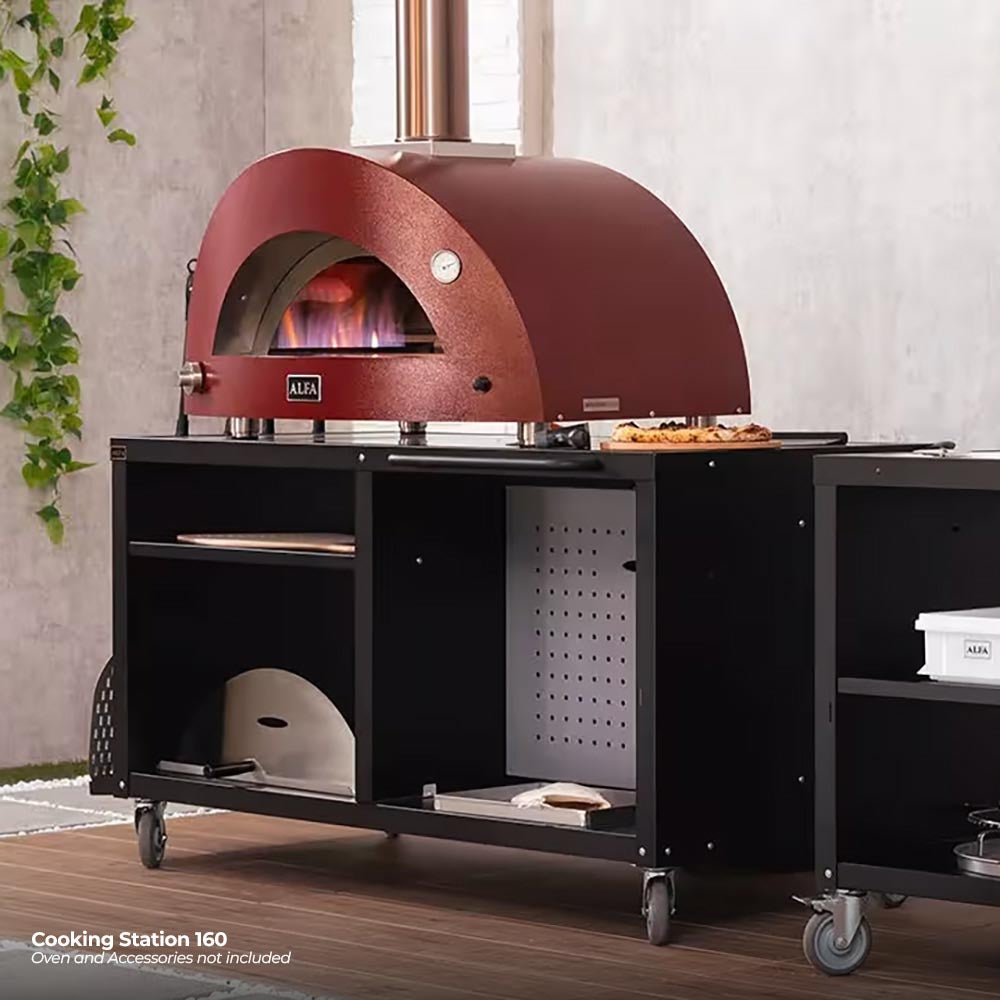 Red domed pizza oven on a black cooking station cart with shelves and casters