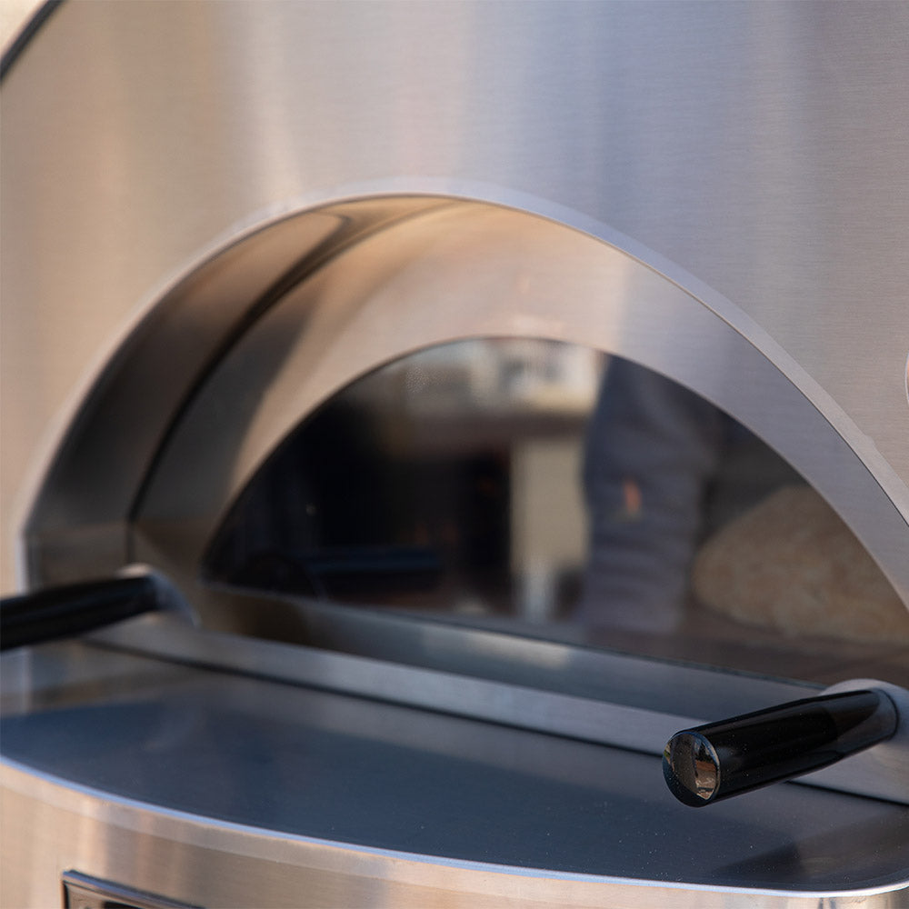 Pizza oven dome interior with arched opening and black control handle