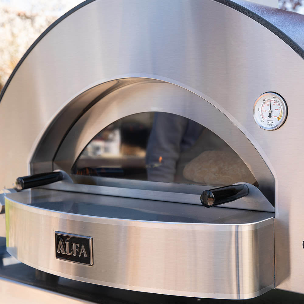Stainless steel pizza oven front with arched door, thermometer gauge, and ALFA badge