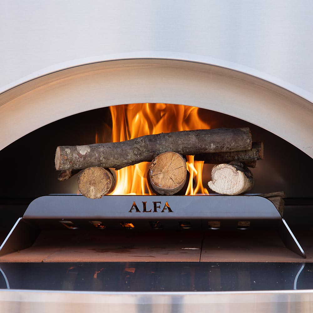 Pizza oven firebox with burning logs and metal 'ALFA' deflector plate