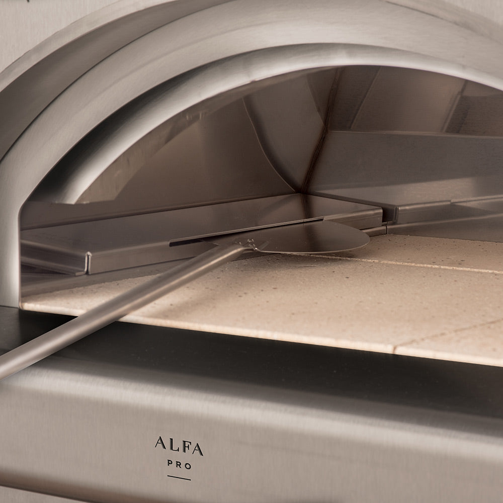 Medium stone pizza oven interior with metal guard bar and rail across opening
