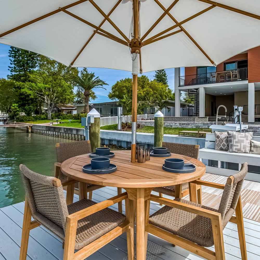 Admiral dining chair on dock patio setting with sand woven back and teak frame