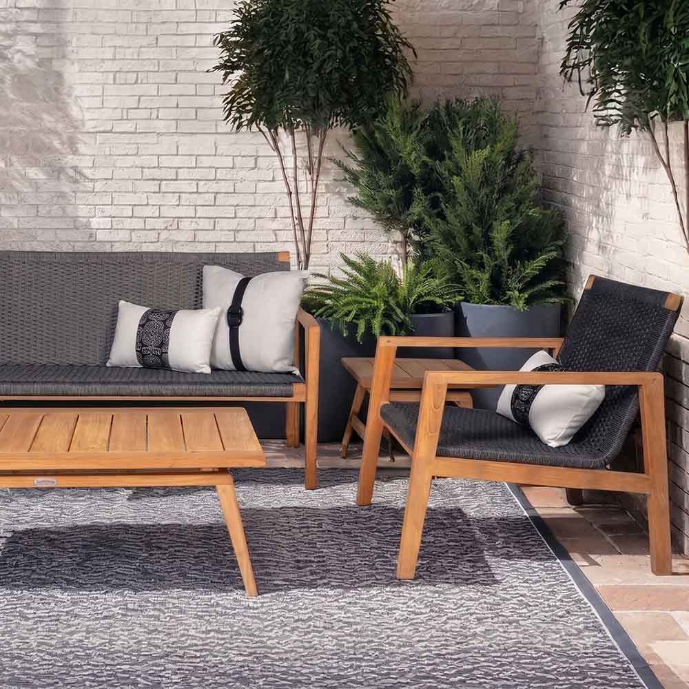Outdoor furniture set with dark gray cushions and light wood frame, including lounge chairs and bench