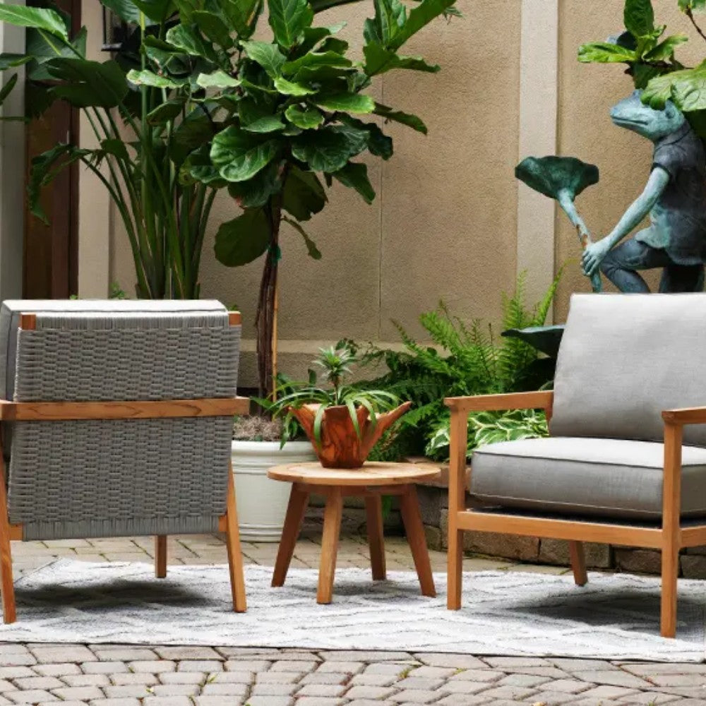 Outdoor round teak side table with slatted top and potted plants