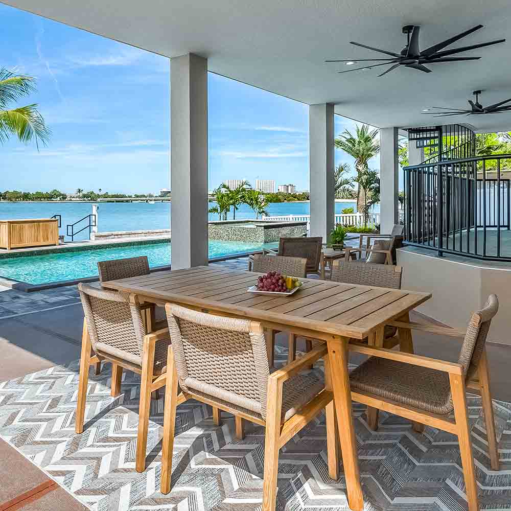 Outdoor dining set with rectangular teak table and woven dining chairs with armrests