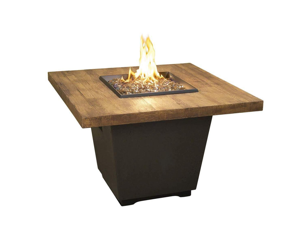 Square reclaimed-wood fire table with black base and central flame from burner
