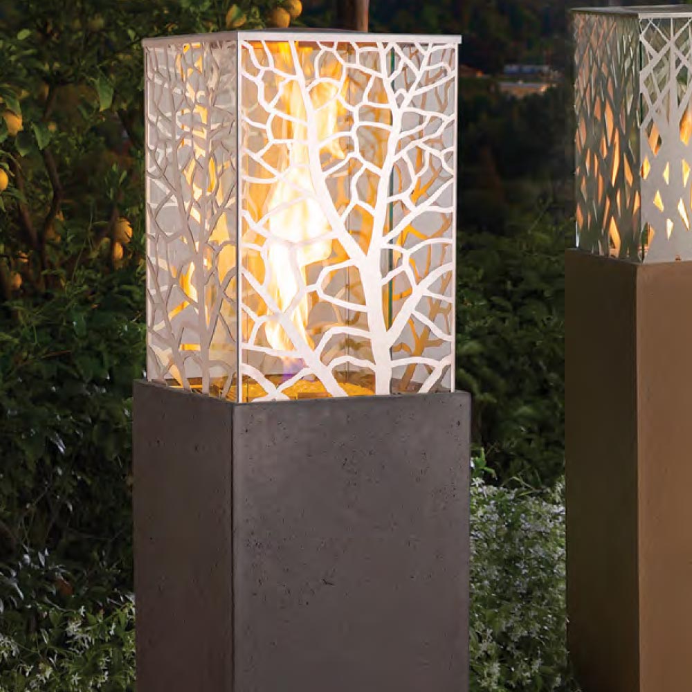 Outdoor square gas fire tower with lit mosaic glass insert and dark GFRC sides.
