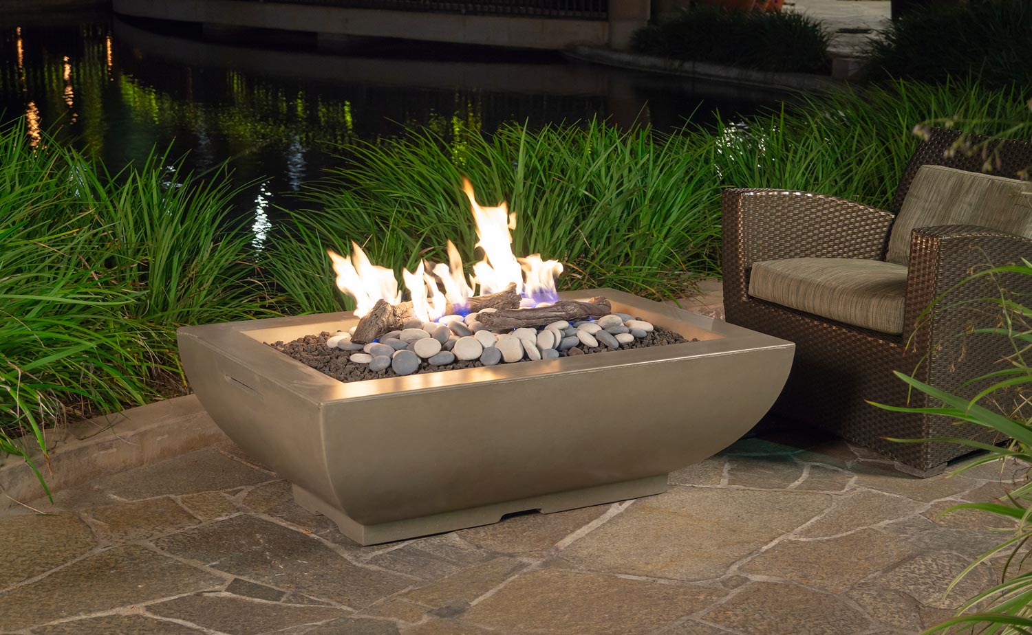 Rectangular fire bowl with beige finish, flames over dark lava rocks