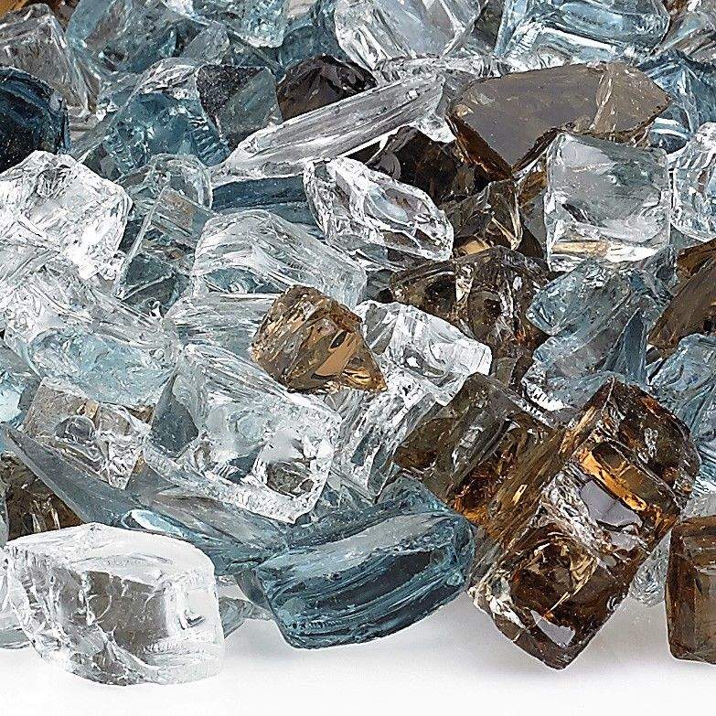 Close-up of reflective fire pit glass chunks in clear, blue, and dark brown pieces