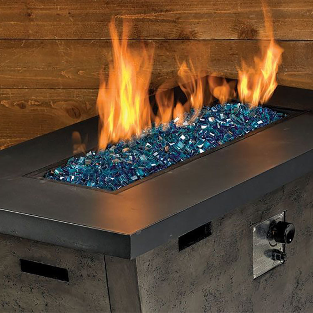 Blue luster fire glass bed burning in a metal fire pit insert