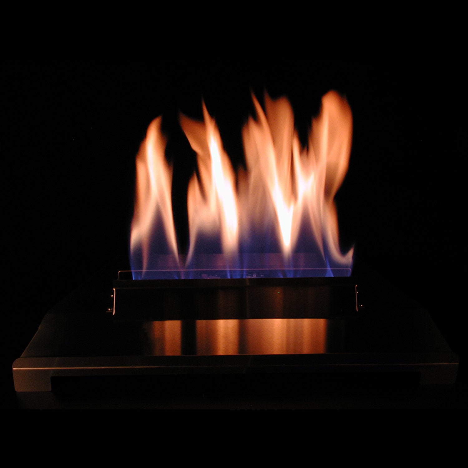 Ventless burner with orange flames over dark metal firebox tray
