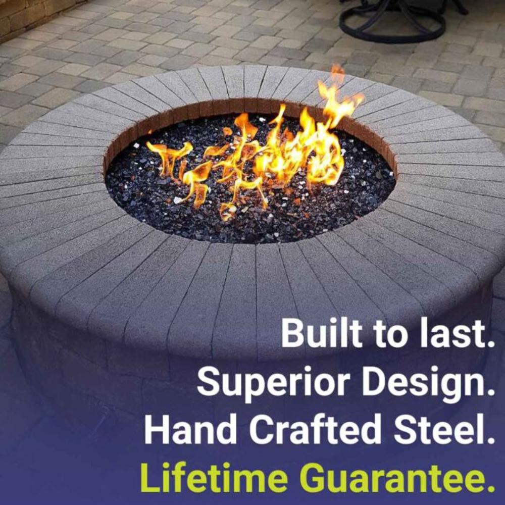 Round fire pit burner pan in use with visible flames over gravel and steel fire ring