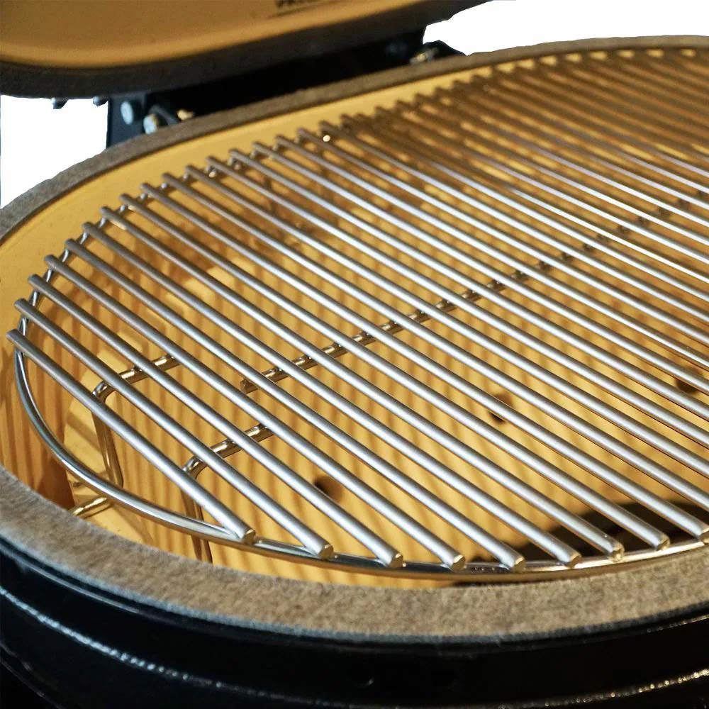 Round grill grate with metal bars inside charcoal oval ceramic kamado
