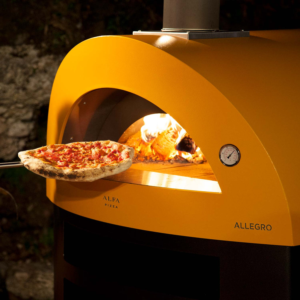 Yellow wood-fired pizza oven with pizza on stone and flame inside the front arch