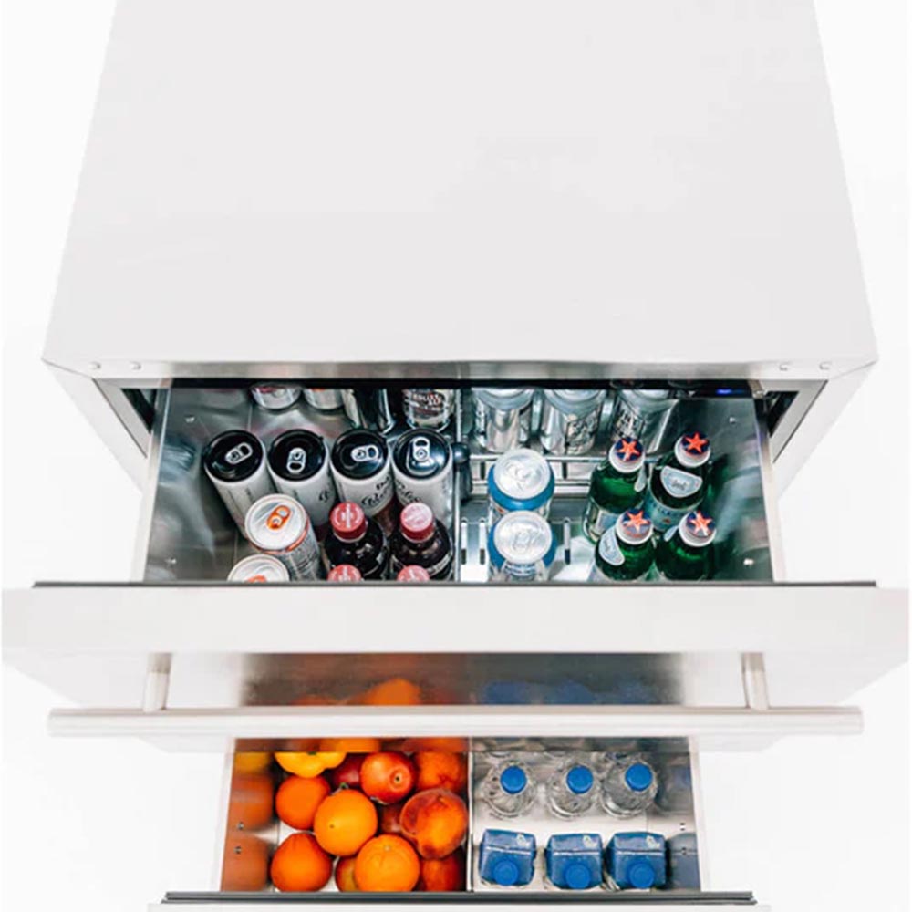 Open drawer fridge with cans and orange fruit inside, front compartment visible