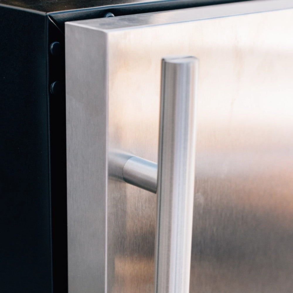 Stainless steel refrigerator handle on white door edge