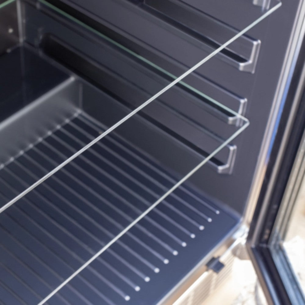 Refrigerator interior with wire shelves and a bottom grill rack